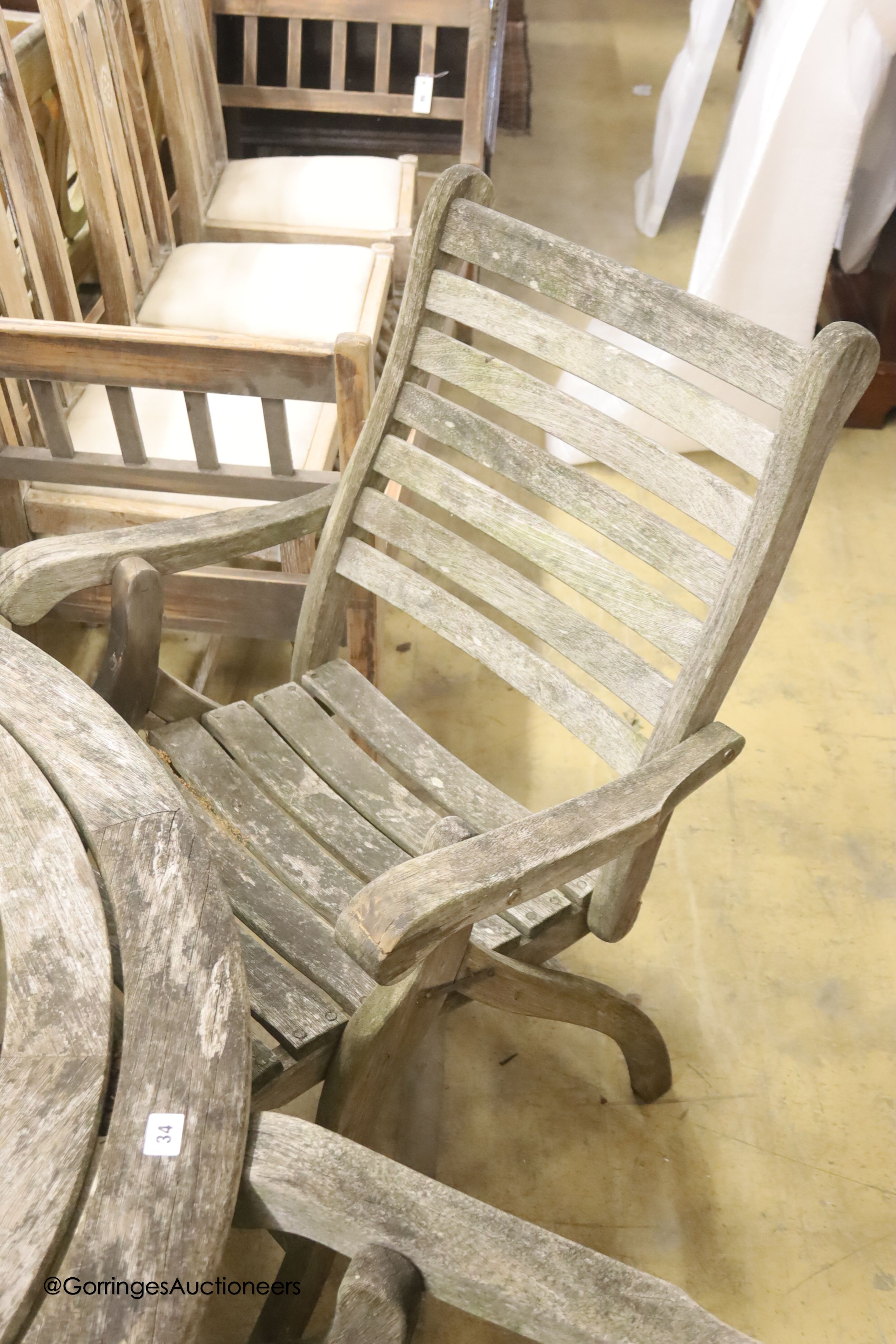 Alexander Rose weathered teak circular garden table, diameter 180cm, height 100cm and four folding elbow chairs